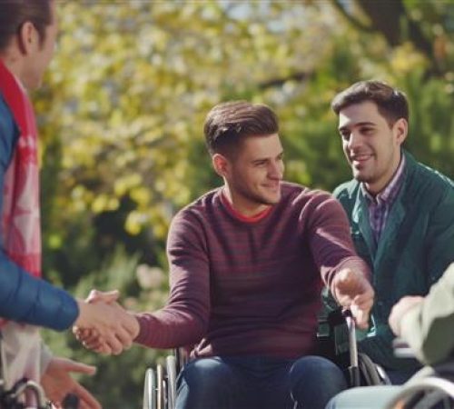 man-wheel-chair-shaking-hands-with-another-man-wheelchair